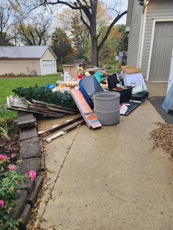 Dumpster being loaded with debris for Commercial Dumpster Rental in West Greenwich